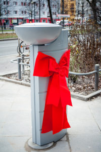 Trinkwasserbrunnen mit roter Schleife